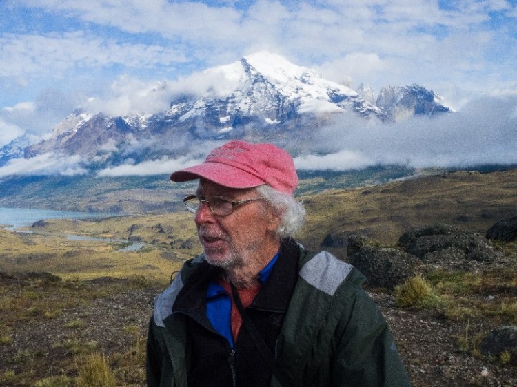 photo of man, probably a hiker, in front of Alaskan mountains